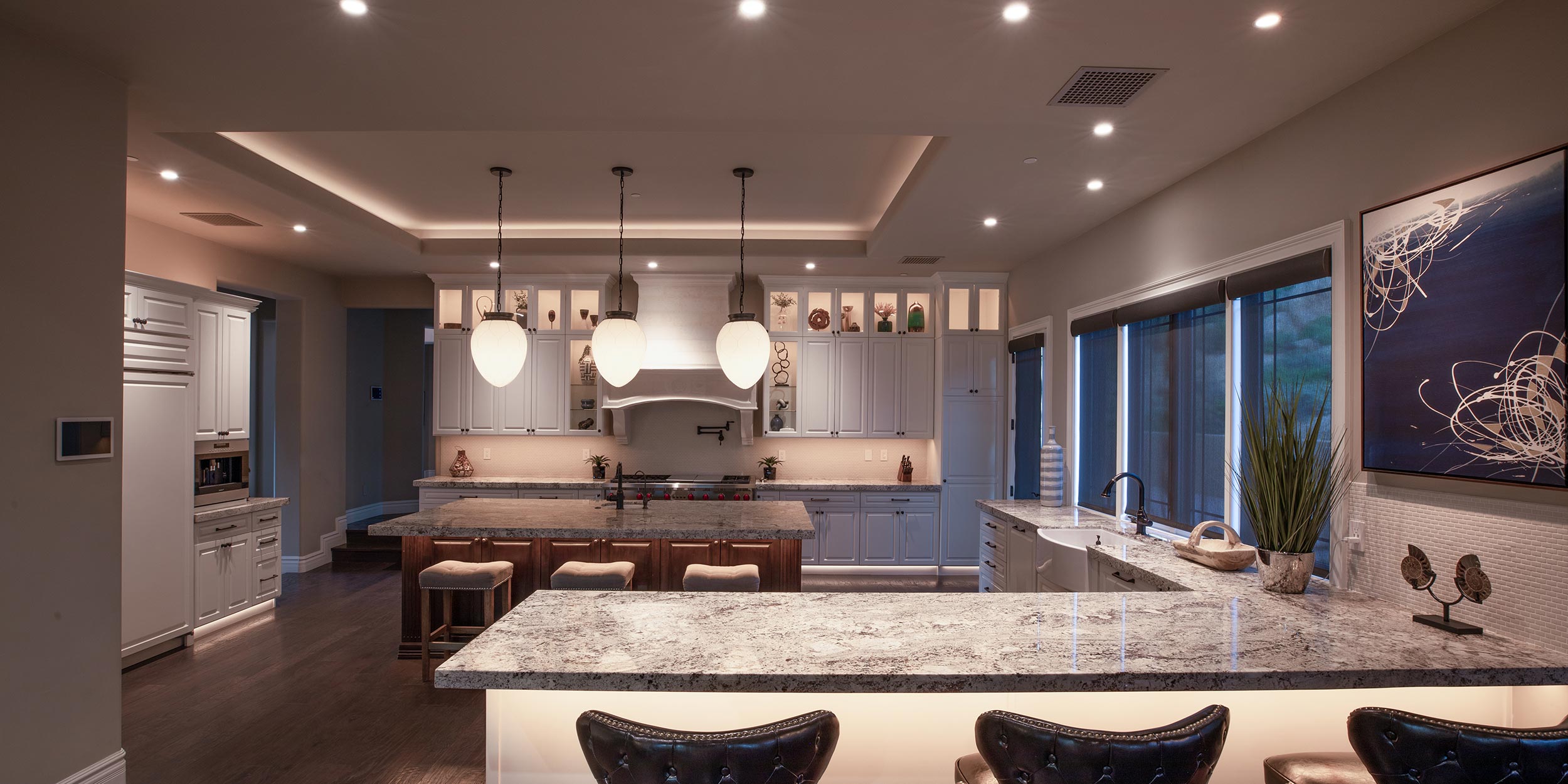 Modern kitchen with glowing under-cabinet and pendant lighting